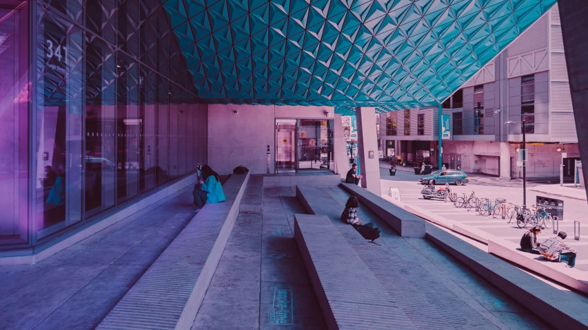 some people in a large building with a blue ceiling