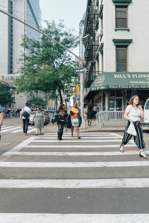 the crosswalk in a busy city with pedestrians crossing