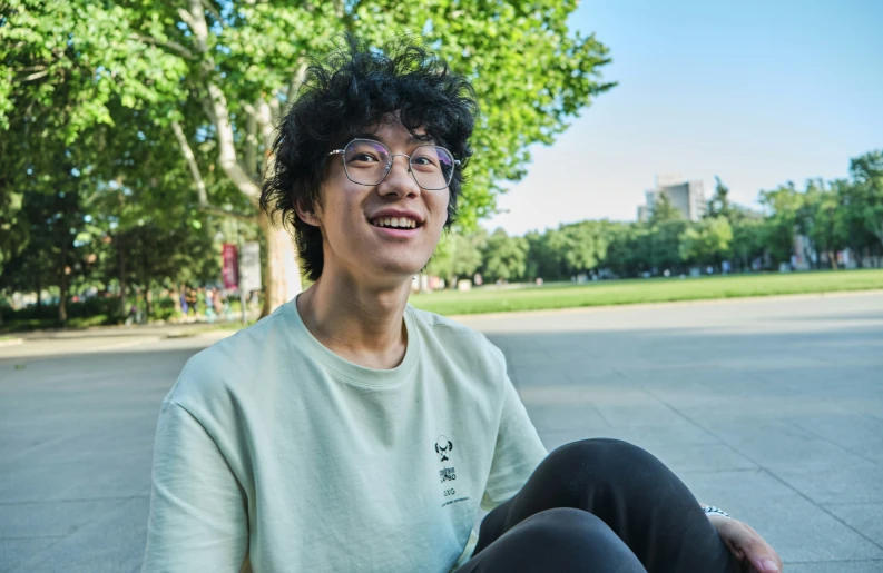 a person wearing glasses and a white shirt