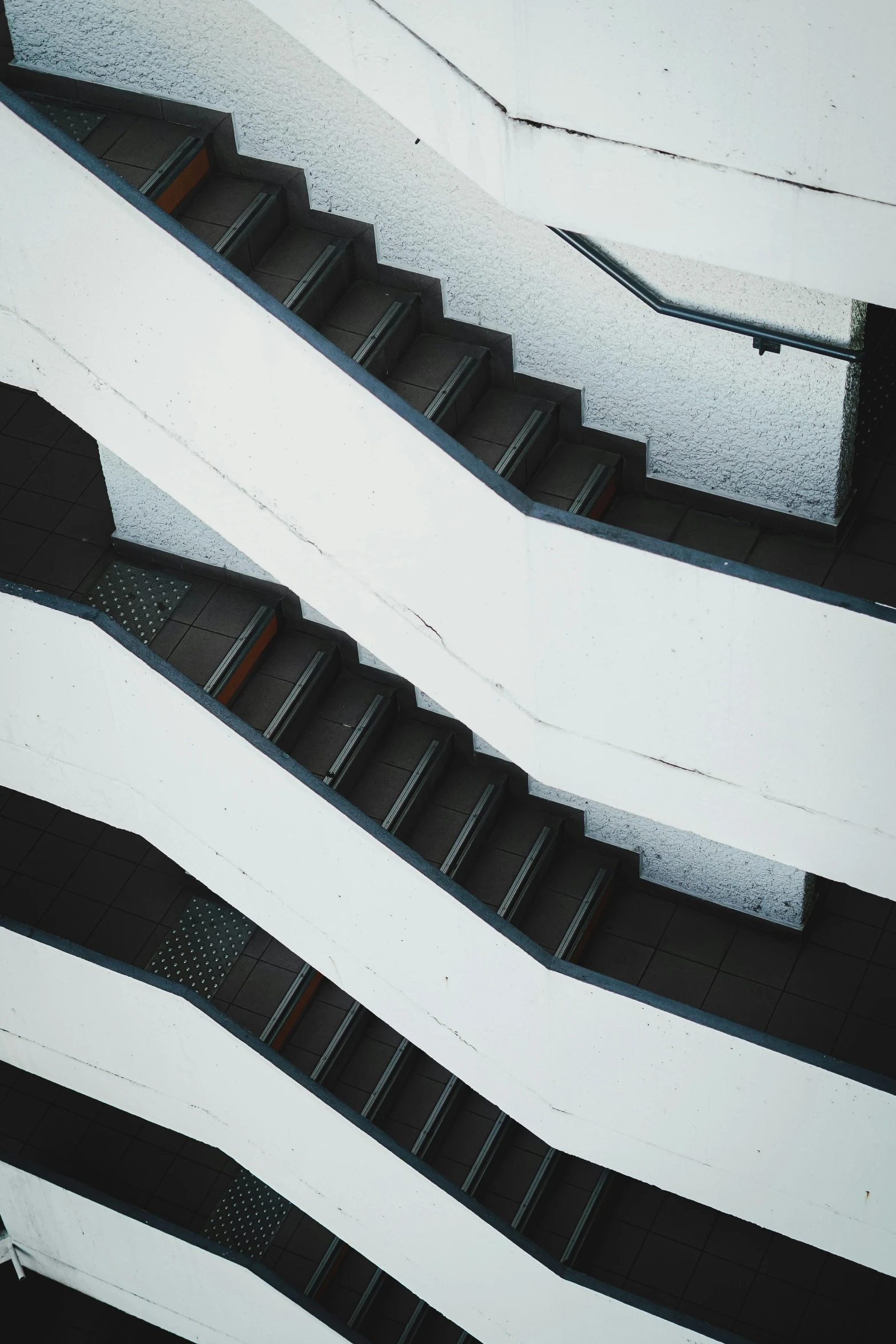 three escalator are seen against a white - frosted sky