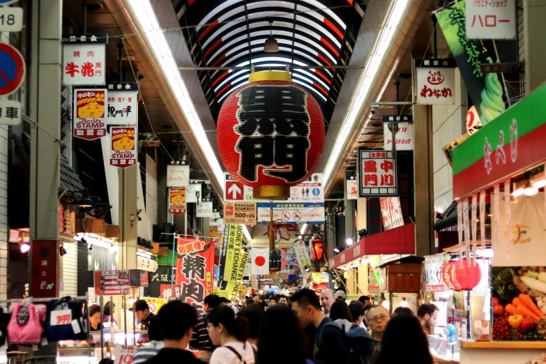 a bunch of people inside a large market with banners all around