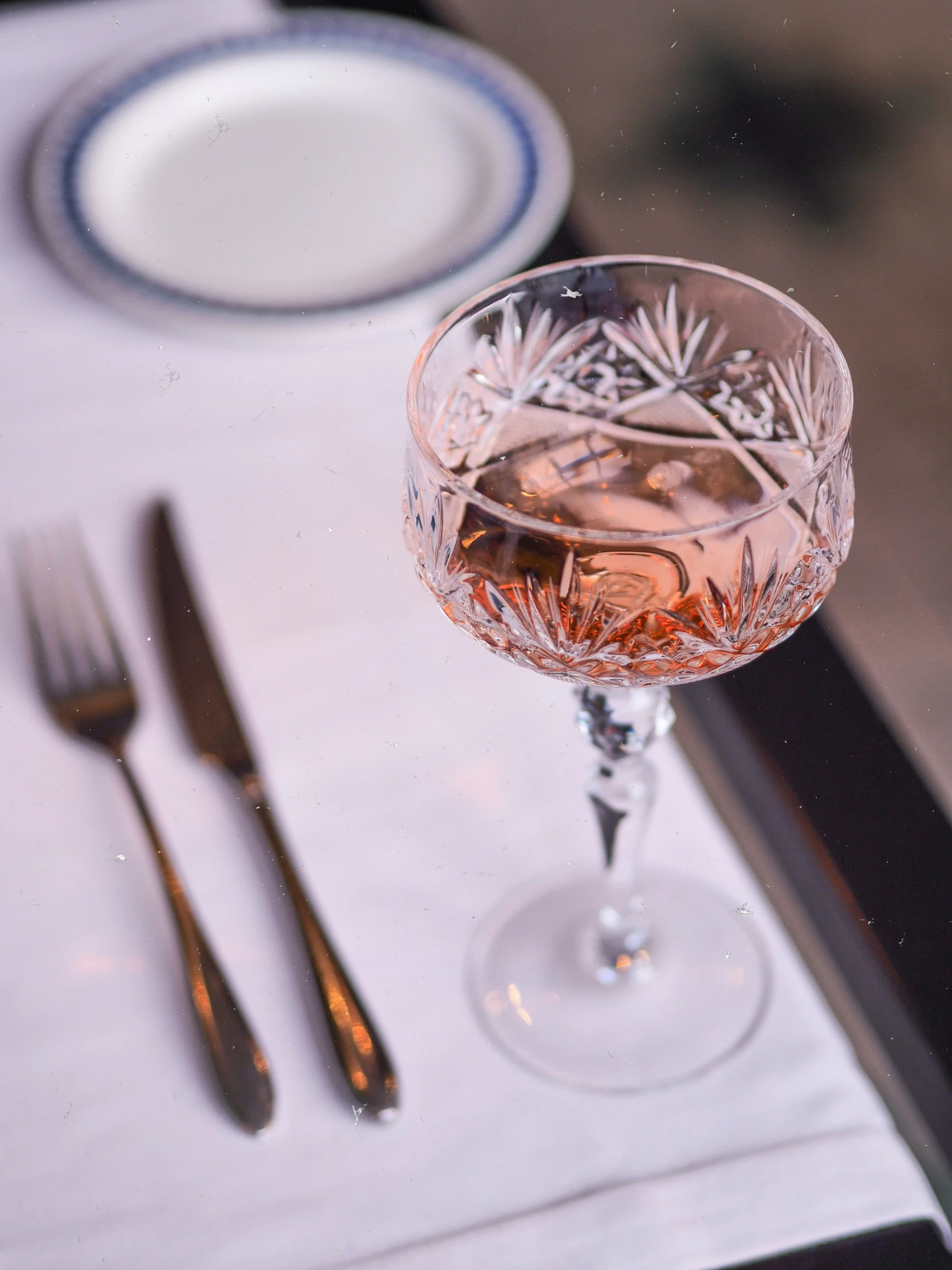 a wine glass on top of a place mat