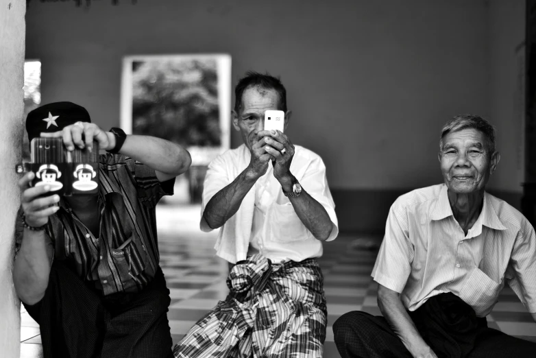 a group of people sitting and taking pictures