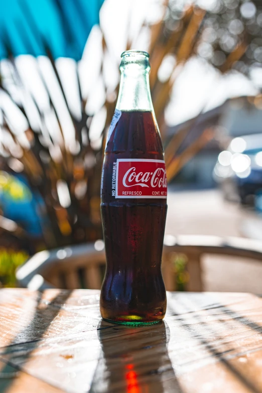 an image of a bottle of coke that is on a table