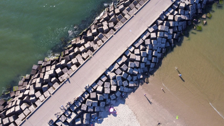 two people walking down the road from a pier