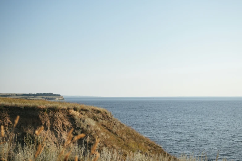 a large body of water sits above a hill