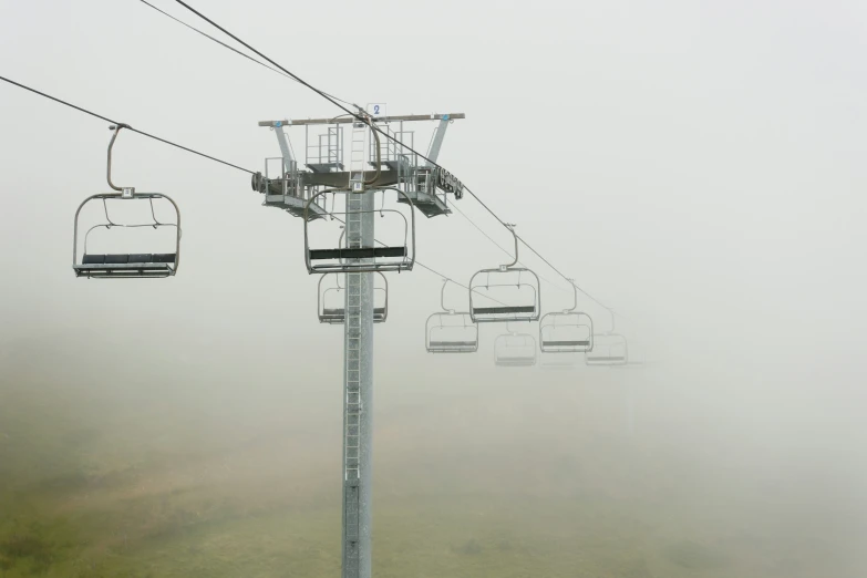 a couple of gondolas that are on a foggy day