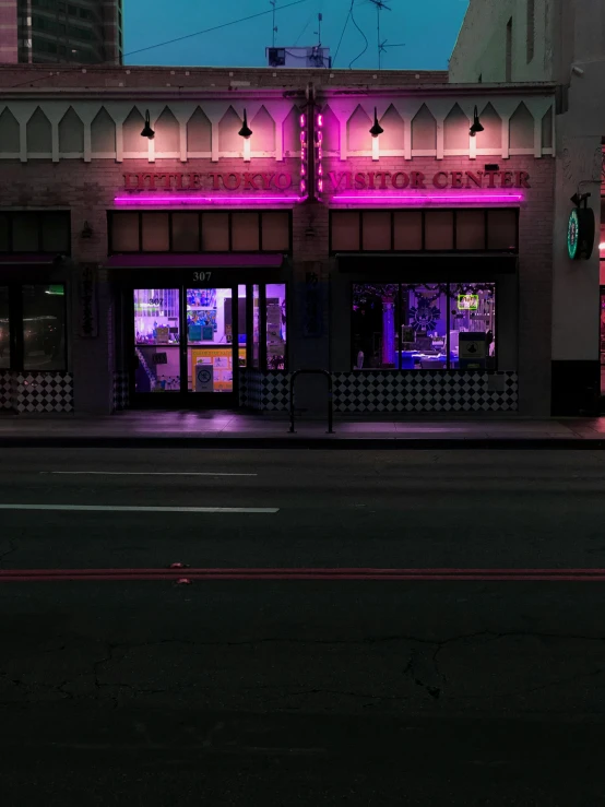 a building on the street that is pink and purple