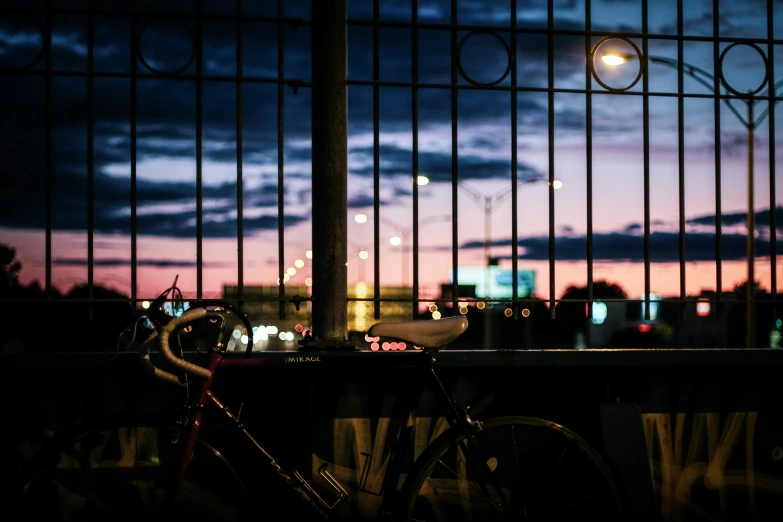 a bike is  to the side of a fence