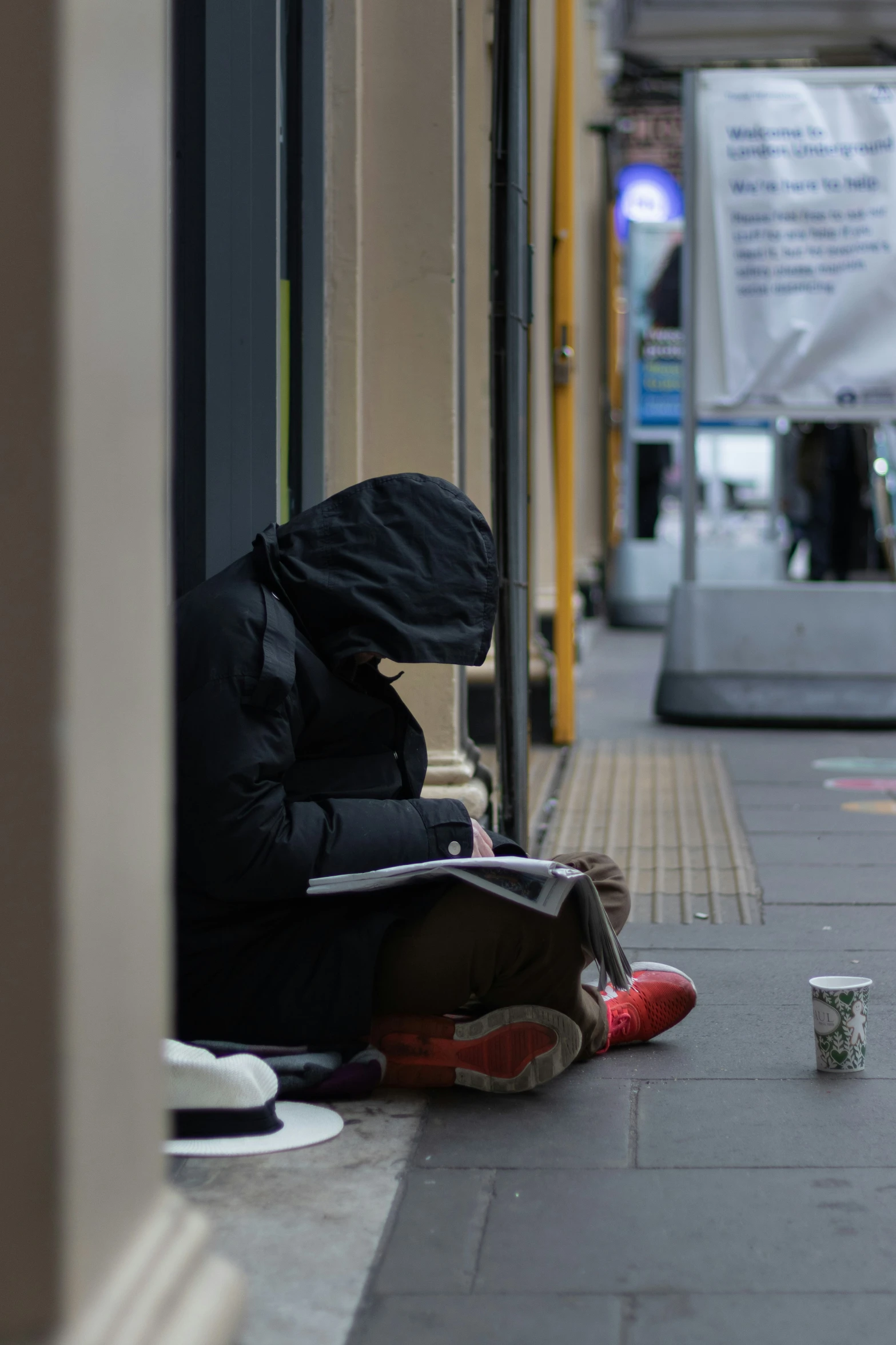 a person with their head in a bag sitting on the ground