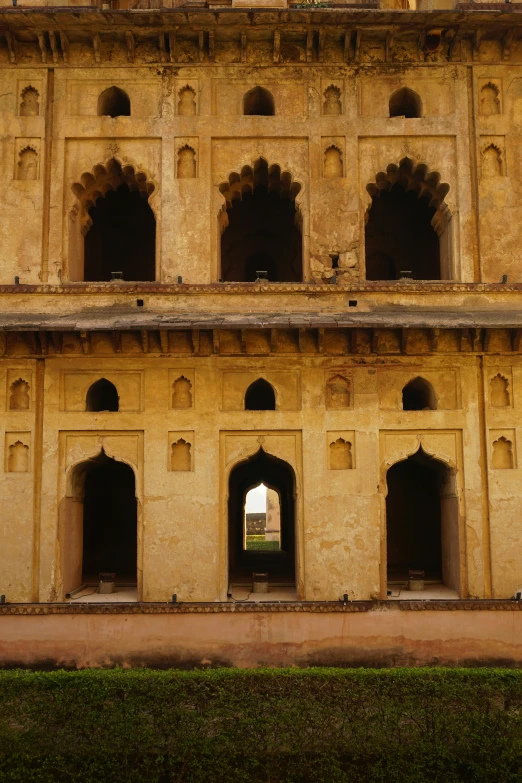 the building is yellow with two arched doorways and no one