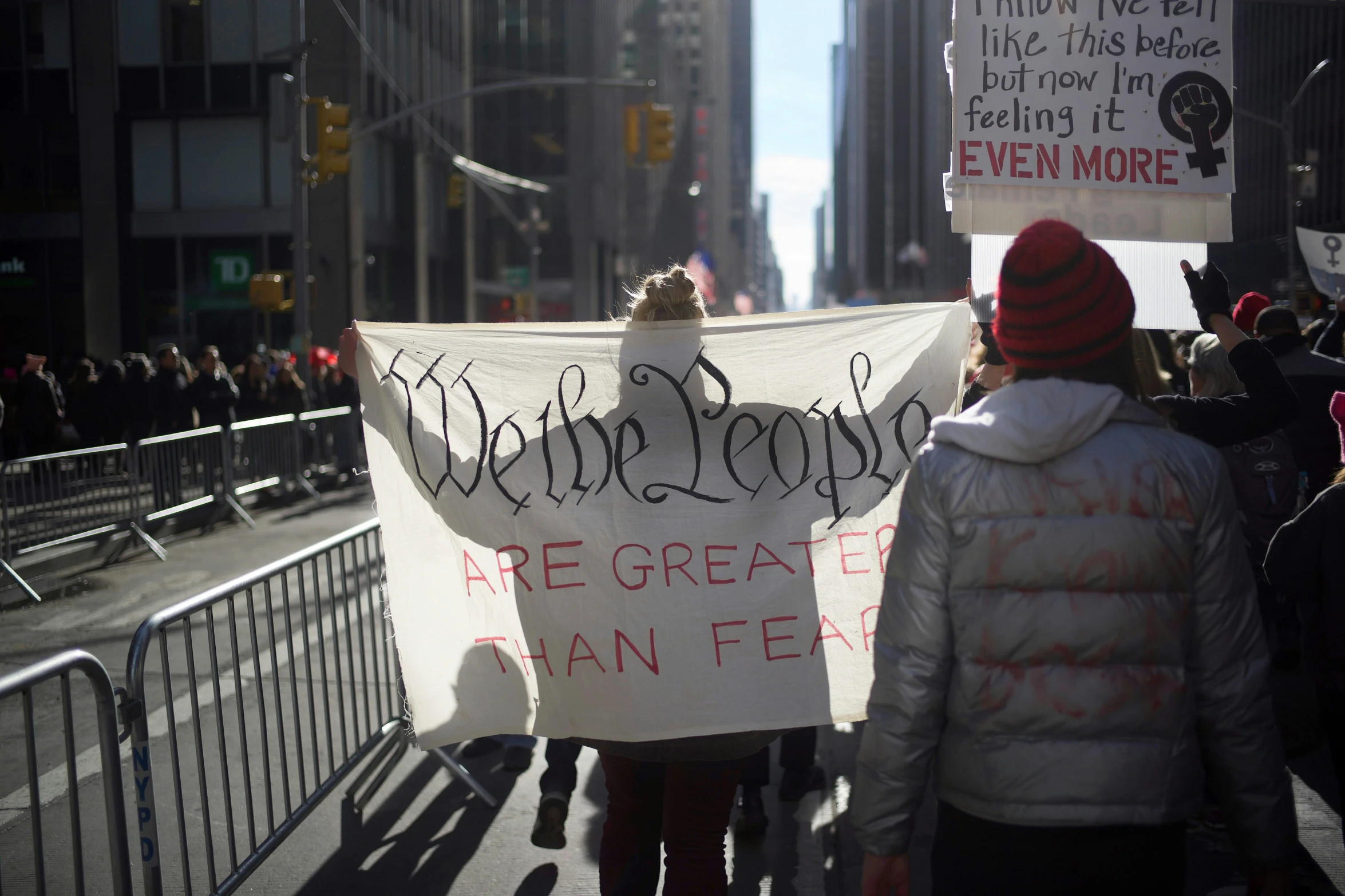 protesters holding signs in the middle of the street