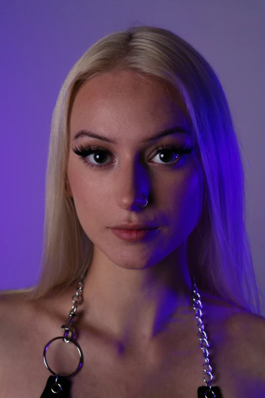 woman posing wearing necklace and black top