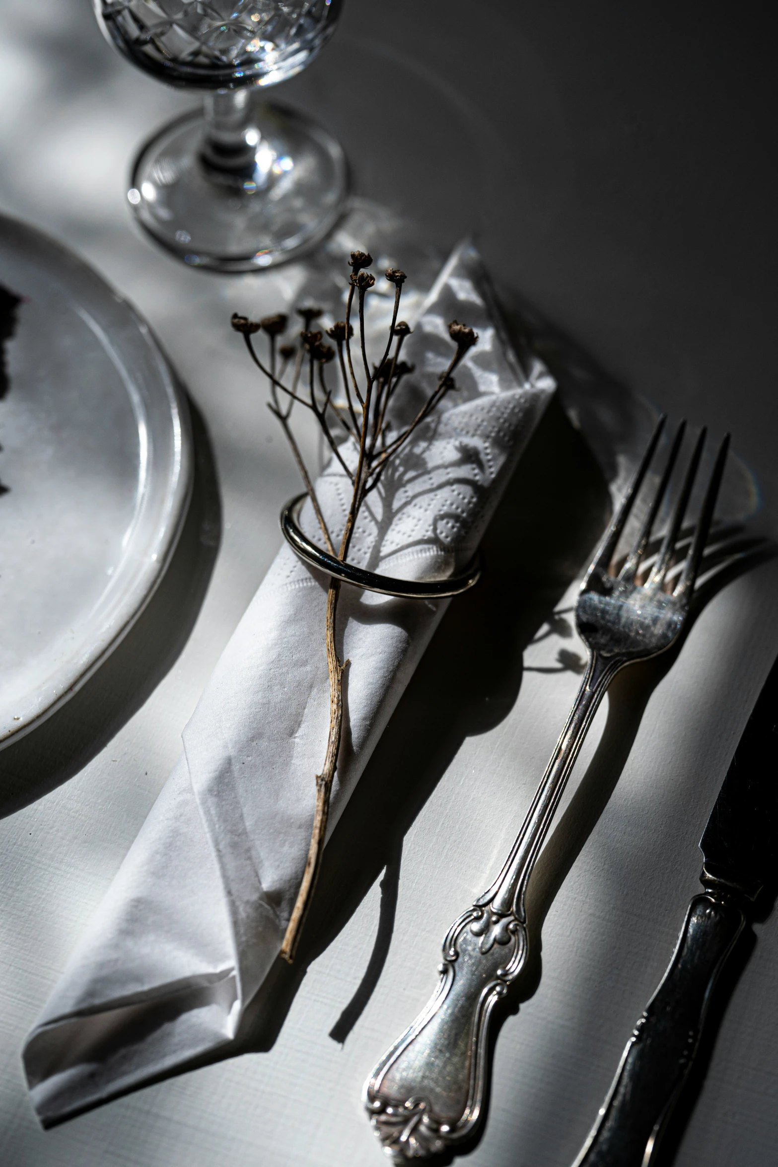 a table setting with floral arrangements and empty utensils