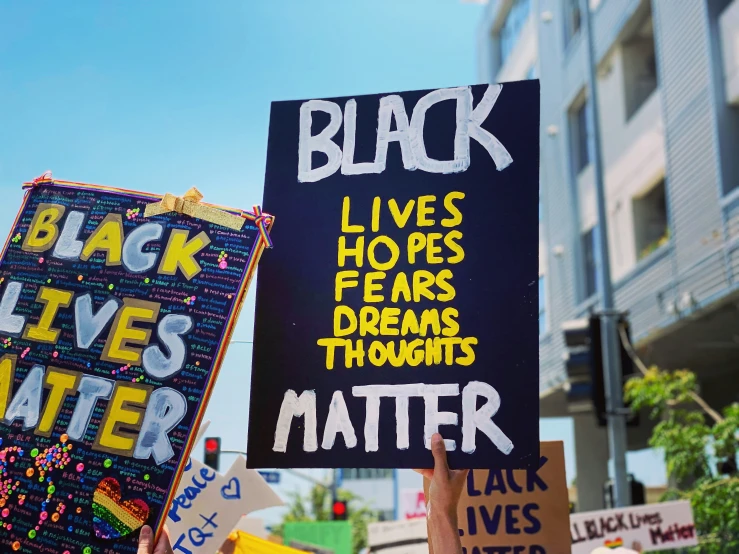 many people holding up black lives matter signs