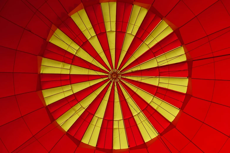 a red and yellow circular picture in the center of a wall