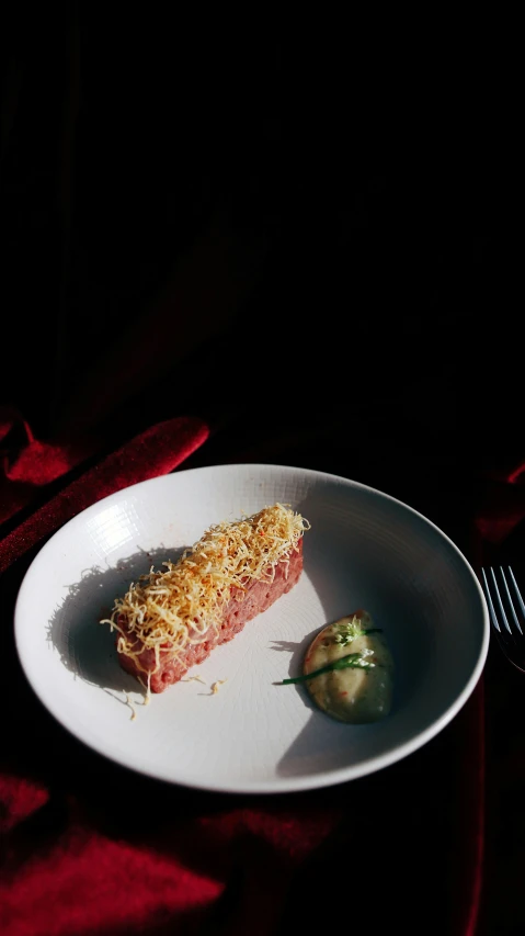 a white plate topped with a piece of food