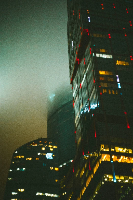 a very tall building sitting in a city at night