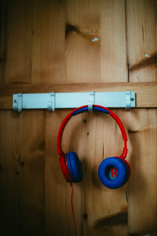 headphones are hanging on a white rail