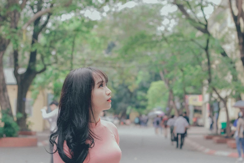 the young woman is standing alone in the street