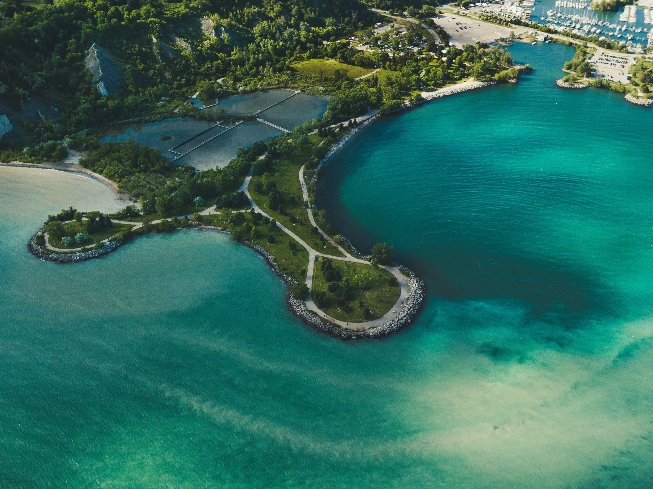 a large body of water surrounded by lush green countryside