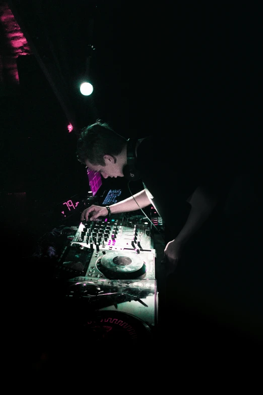 a dj spinning music disc in the dark