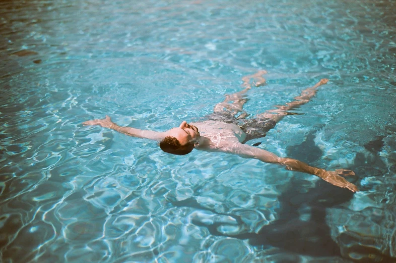 a man swims through an almost empty pool