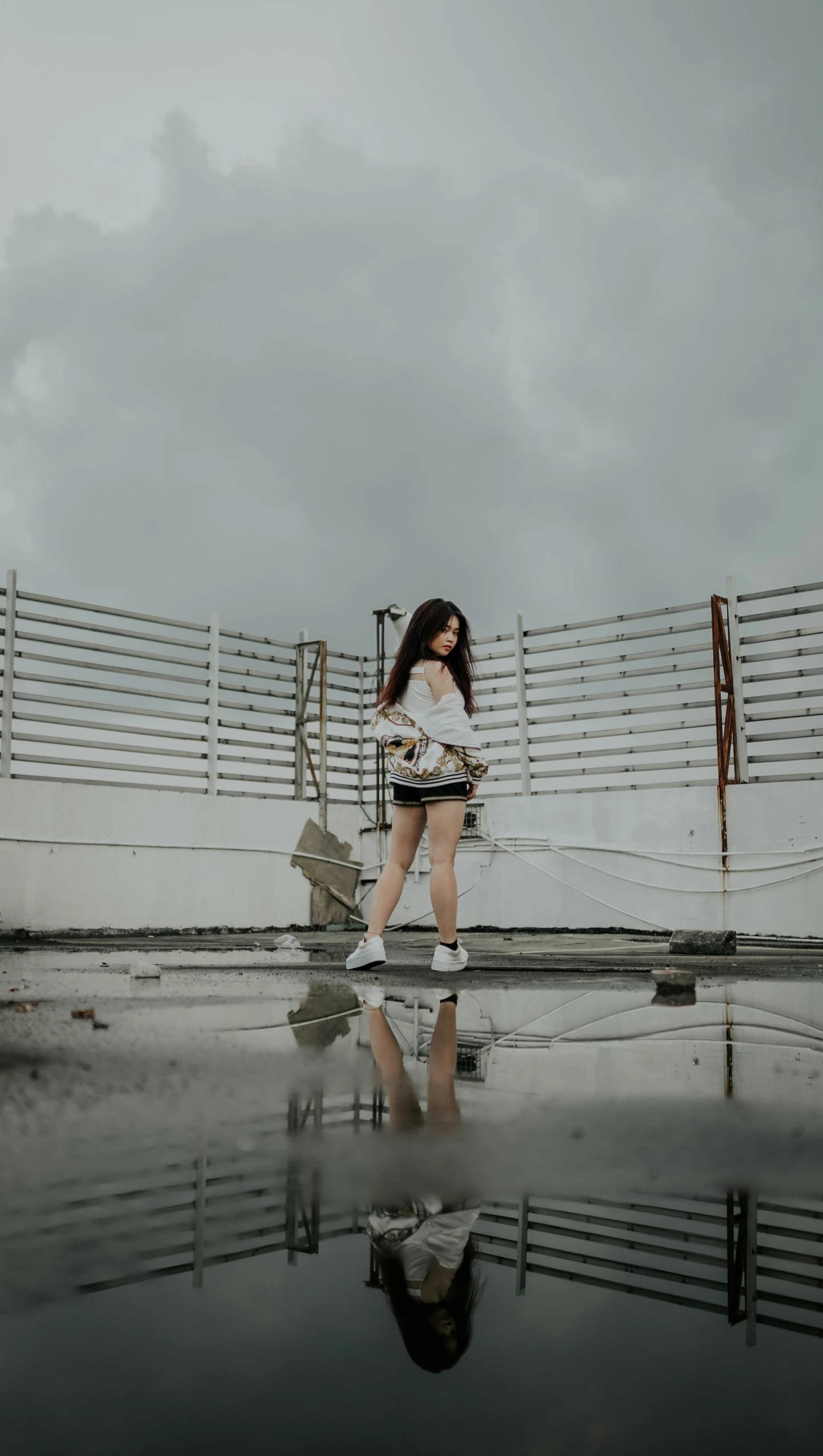 a woman standing in the rain with her hair blowing