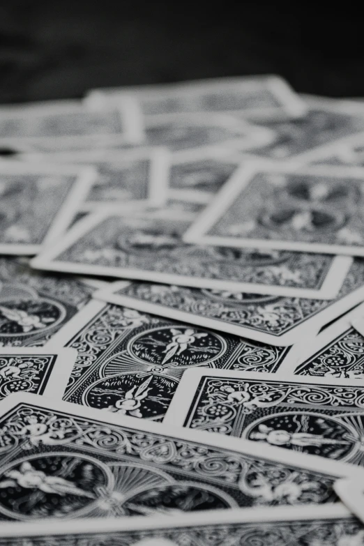 playing cards sitting on the table top in black and white