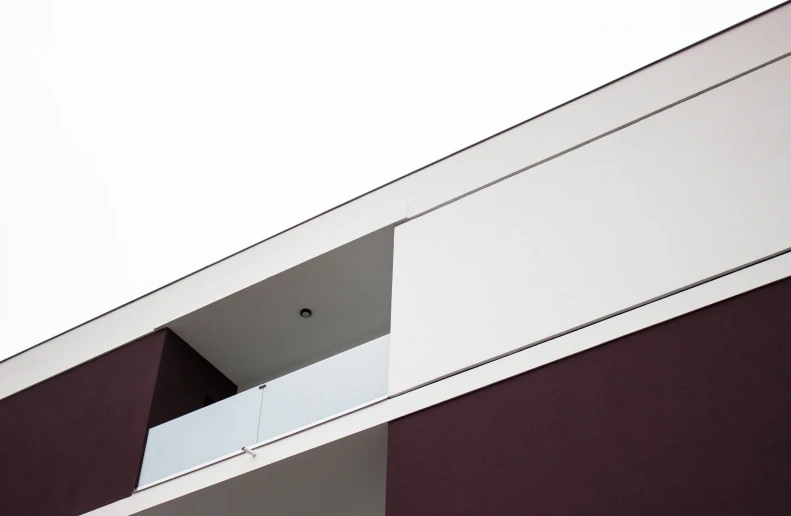 a building with an opening door and a sky background