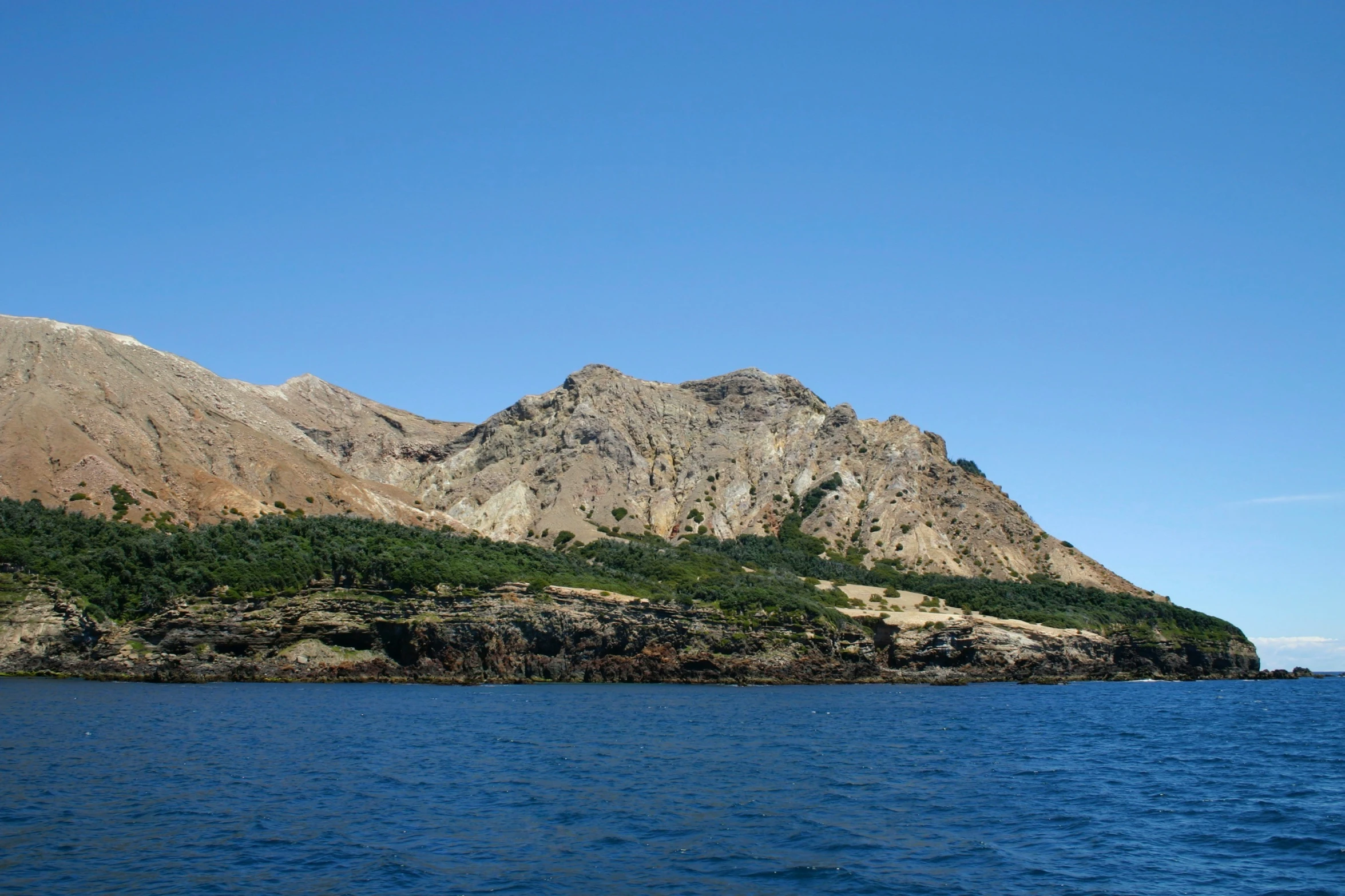 a large body of water with mountains in the distance