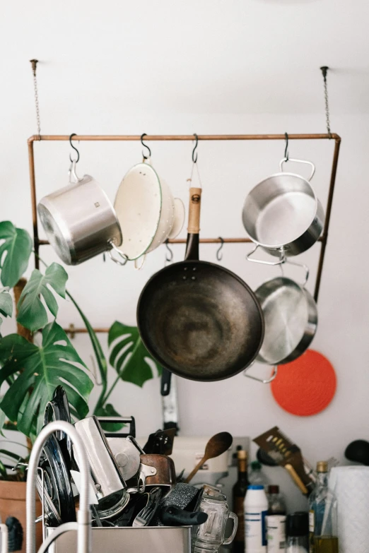 a kitchen that has pots and pans hanging on the wall