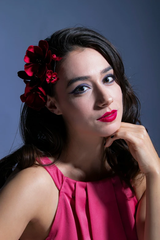 a girl in a pink shirt with a flower in her hair