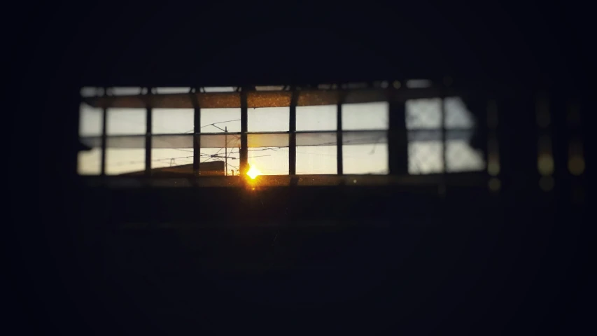 a window and sunset in the sky behind