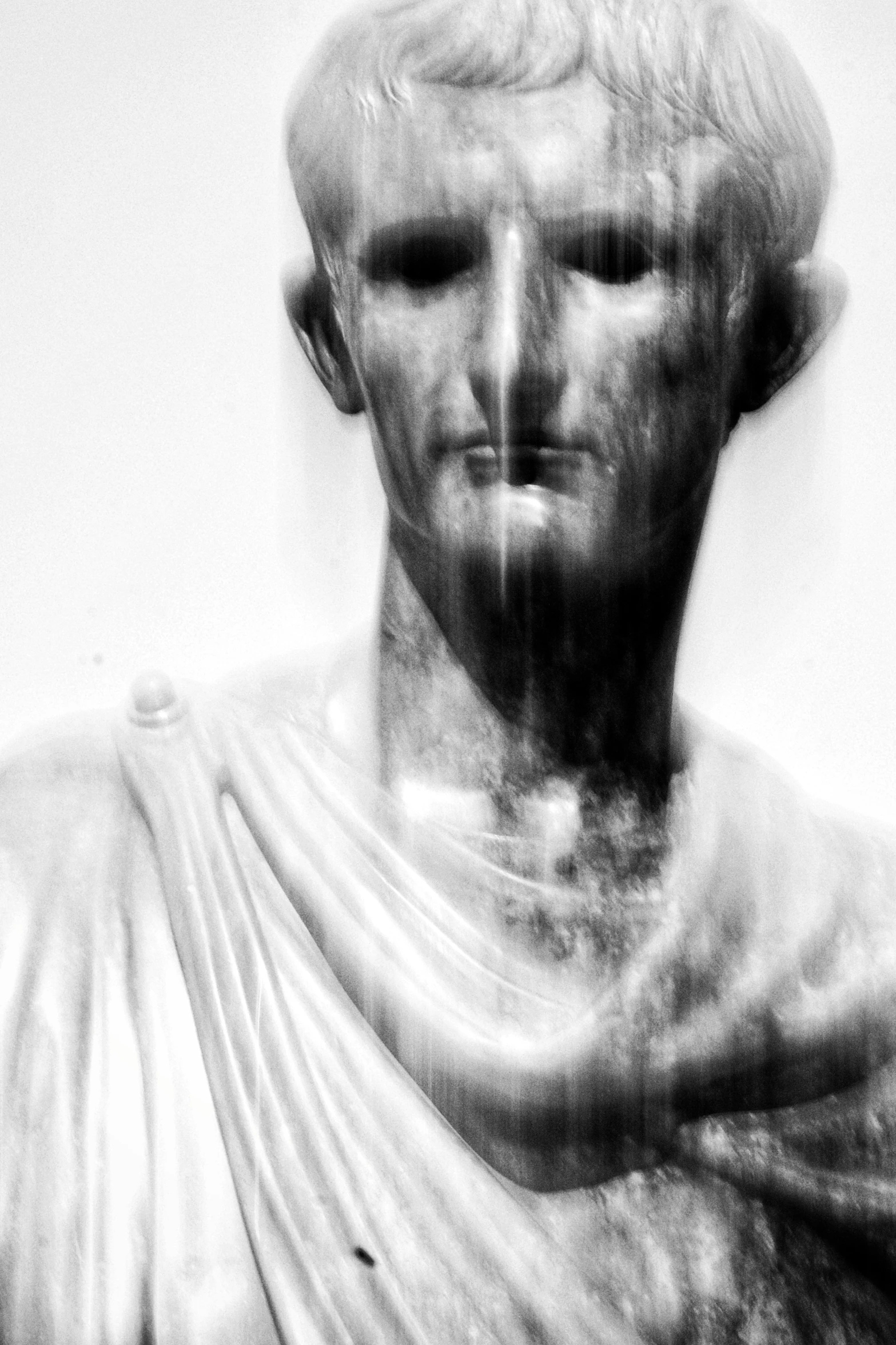 a statue is shown in black and white with some faded up