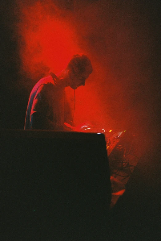 a man in a black shirt and pants is typing on a computer