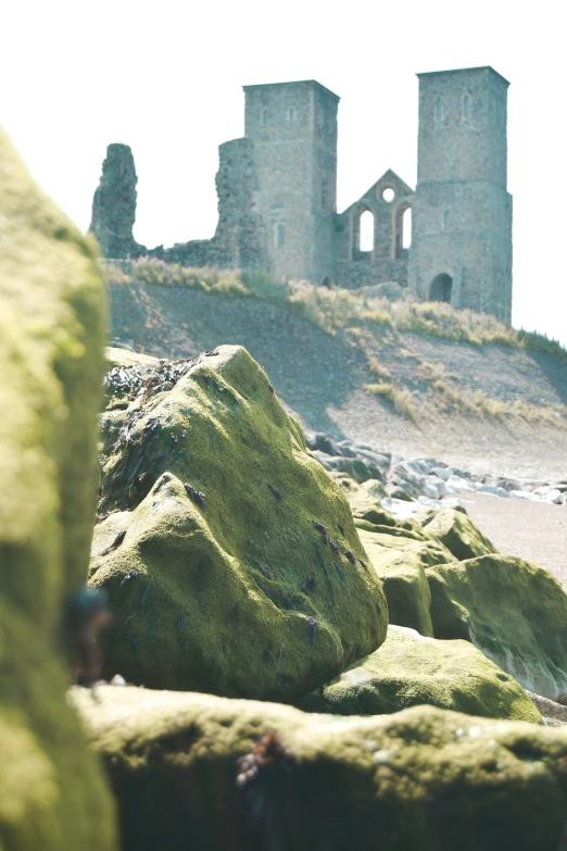 an image of the stone structures of a castle on the beach