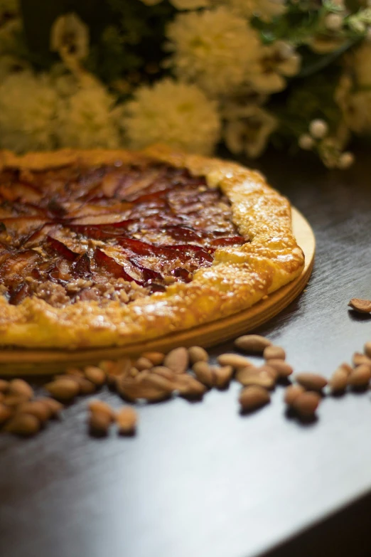 a pizzeria pie with pecans and nuts on top