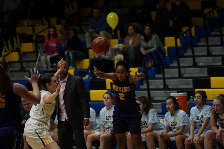 girls basketball game being played with two opposing teams