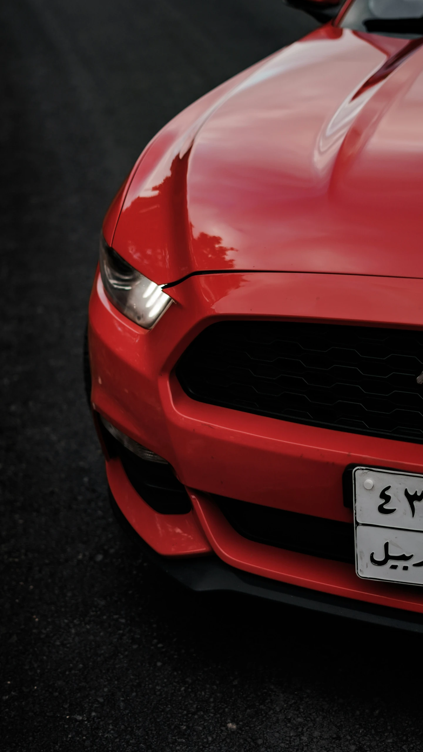 a close up of a red mustang car