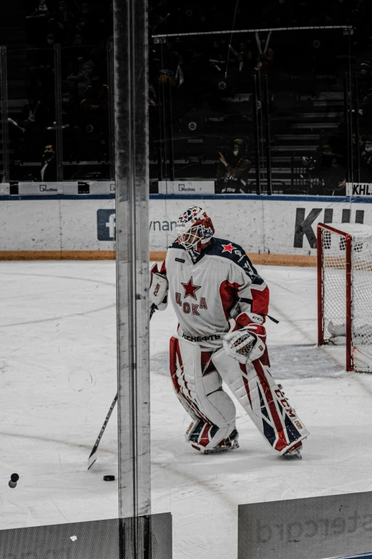 the hockey goaltender is getting ready to take his place