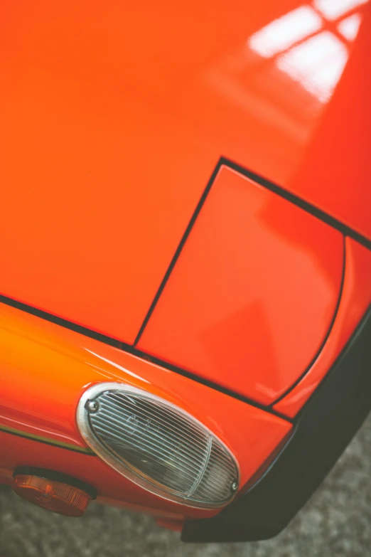 the front part of an orange sports car