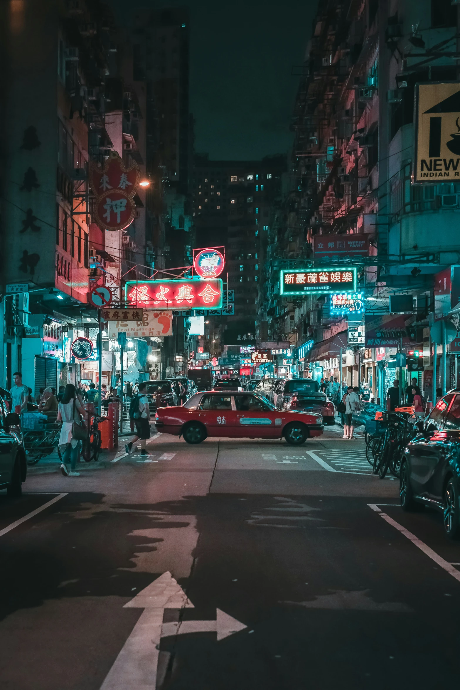 a city street with cars driving in the night