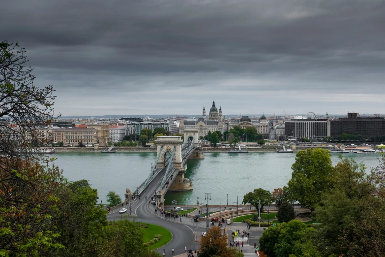 a bridge that is over water near some buildings