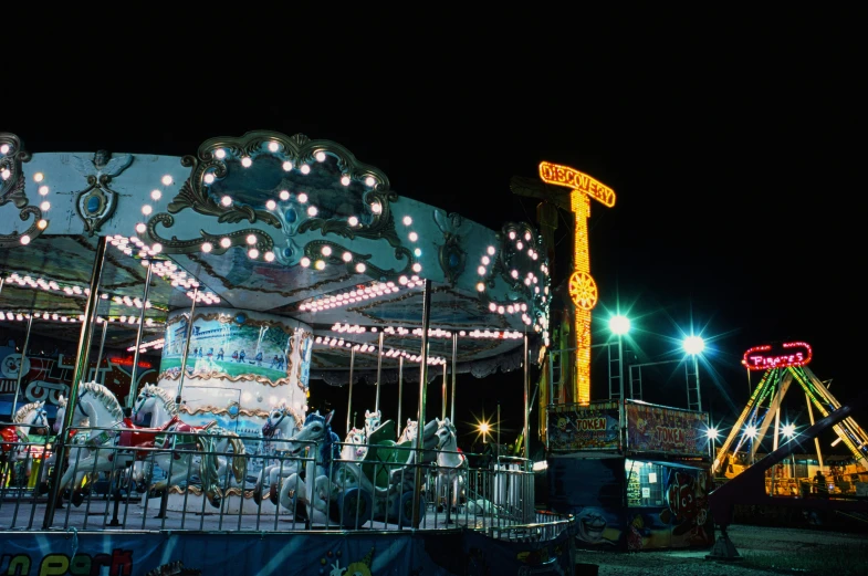 an elaborate lit merry go round at night