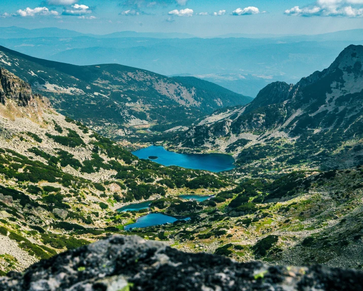 a view looking down on a lake in a mountain valley