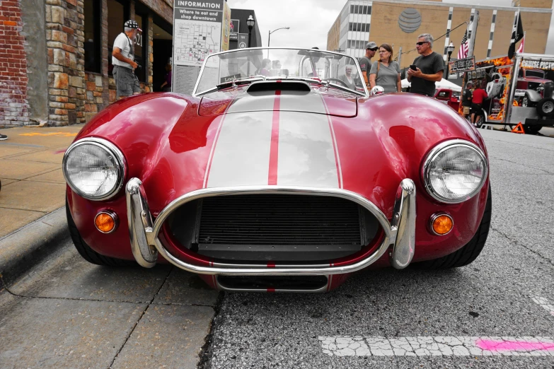 a classic sports car is shown in red and white