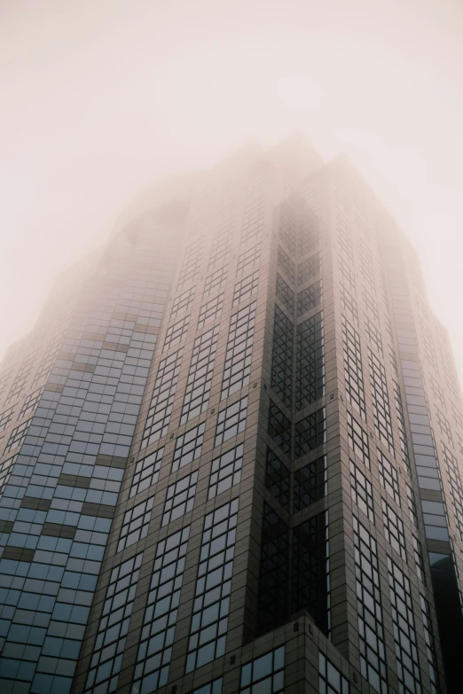 a tall building is covered in a cloud