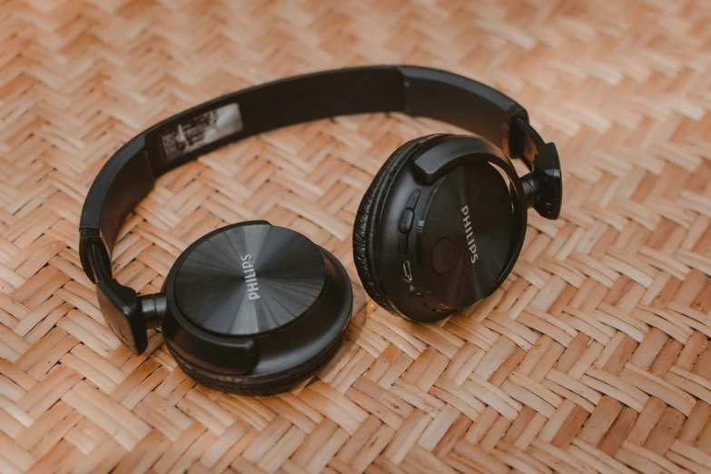 a pair of headphones that are laying on a woven basket