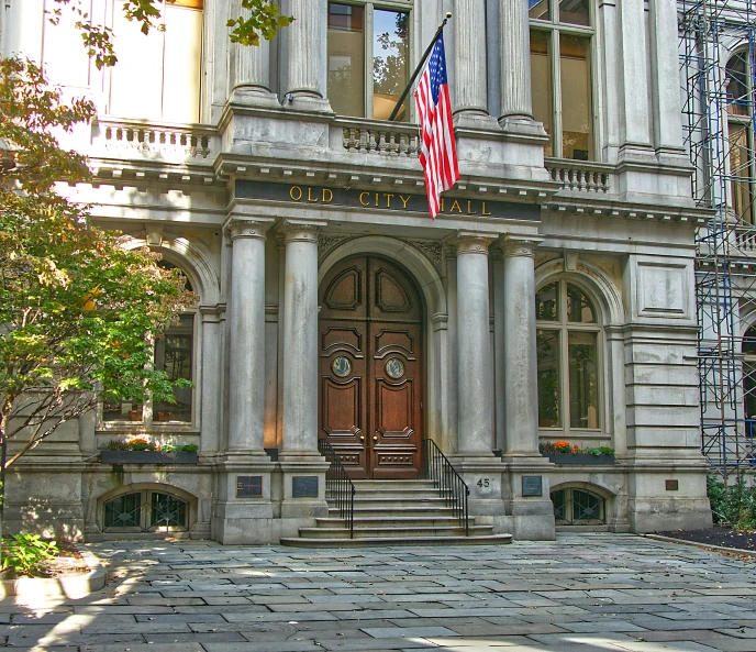 an old building with a staircase and entrance covered in columns